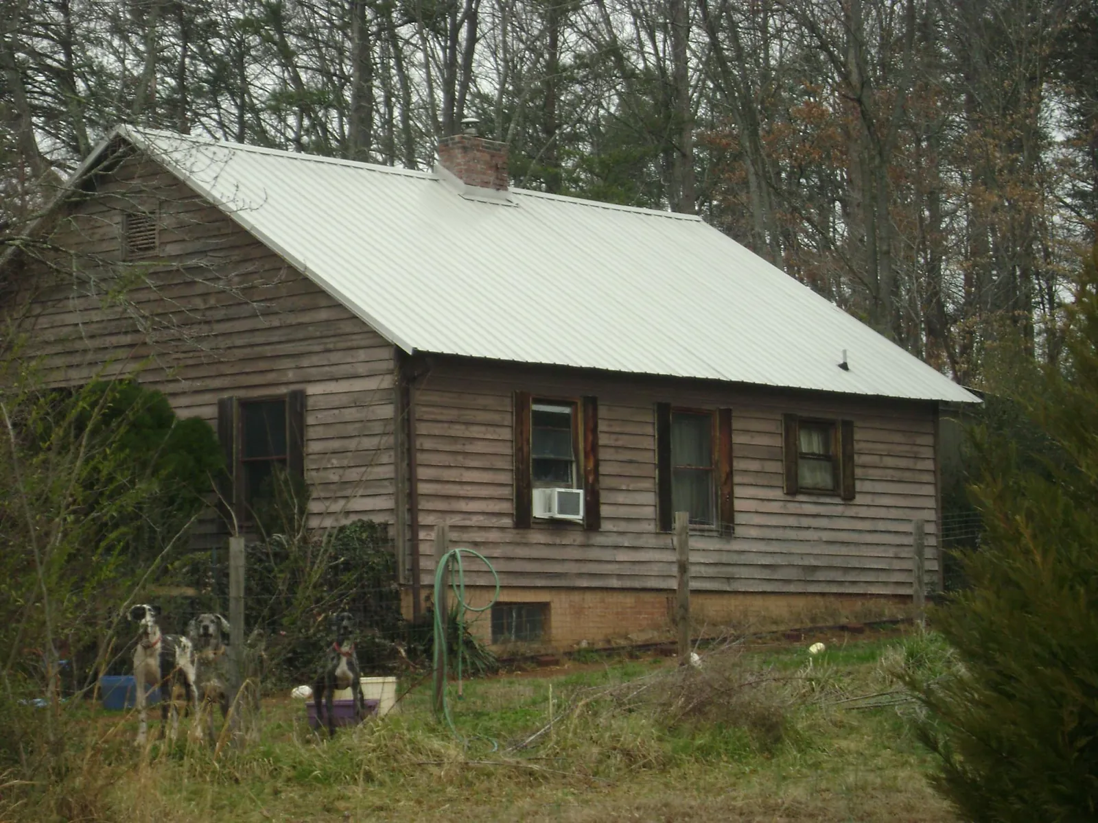 White metal roof on an old wood sided farmhouse, from a Metal Roof Installation job in Allenwood